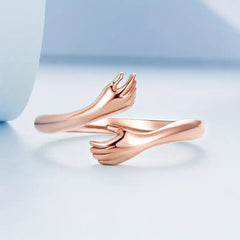 A 925 silver open ring with a rose gold finish, designed with a hug shape, perfect for a sentimental gift.