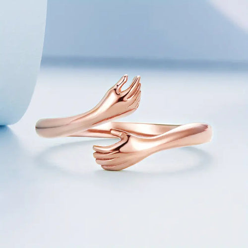 A 925 silver open ring with a rose gold finish, designed with a hug shape, perfect for a sentimental gift.