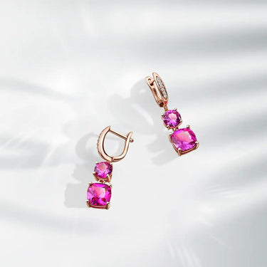 Rose gold earrings with pink gemstones.