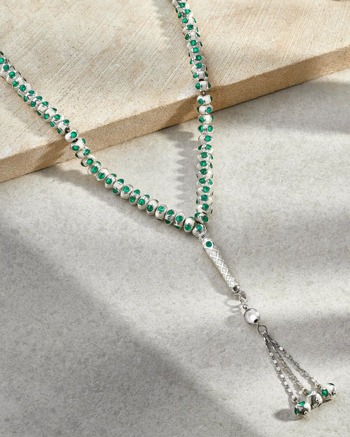 Silver and green beaded prayer beads.