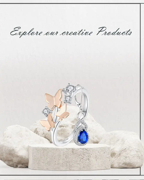 Butterfly-themed silver ring with blue gemstone.